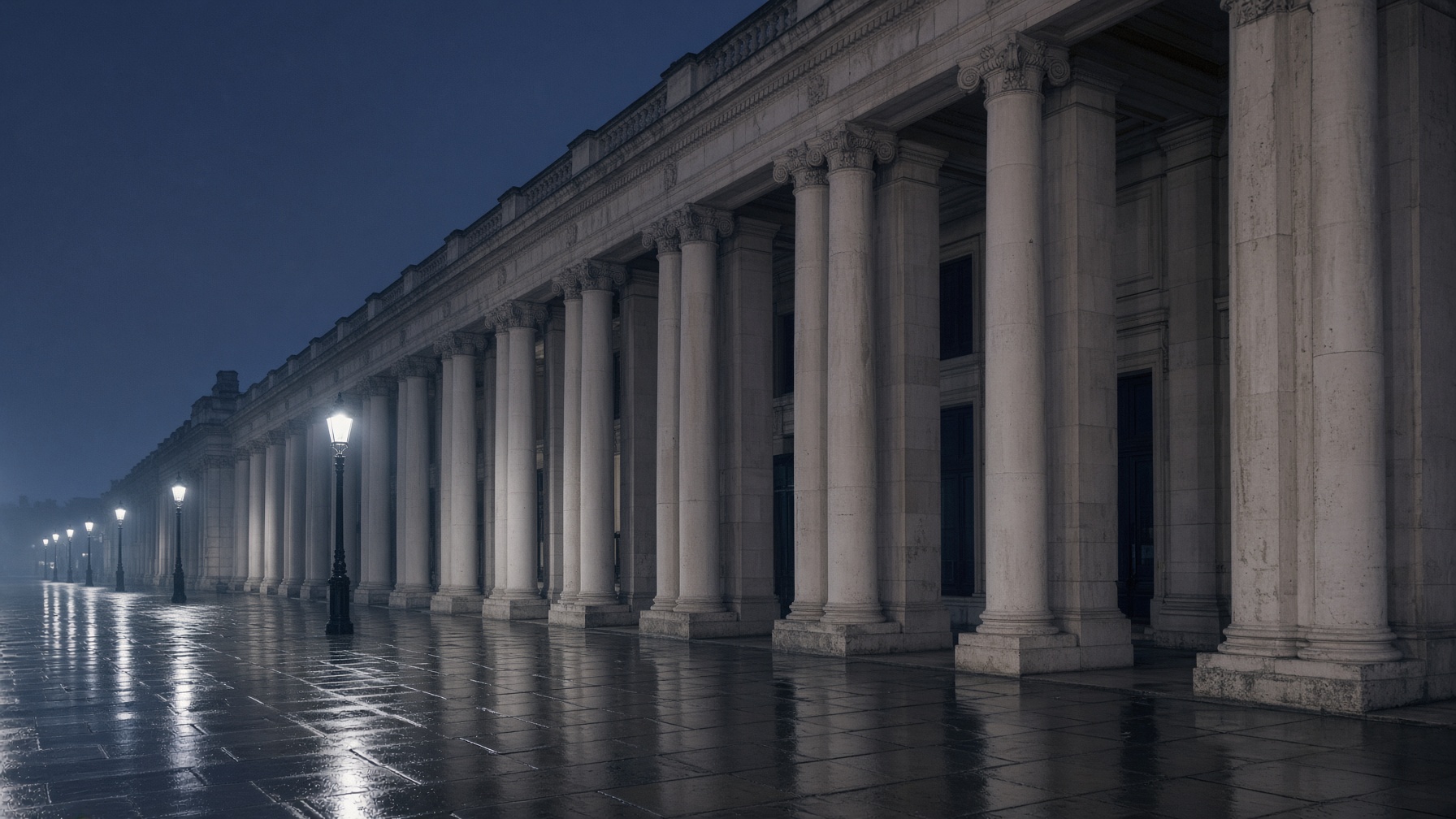 A Portland-stone colonnade in the City of London at dusk.